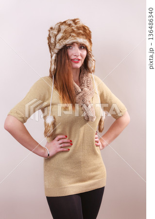 Winter woman in warm clothing fur cap Winter woman in warm clothing fur cap 136486340