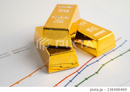 Gold bars on graph paper, finance trading investment business currency. 136486469