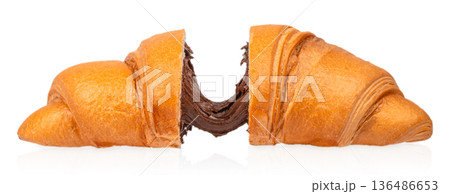 Split croissant with melted chocolate filling isolated on white background Split croissant with melted chocolate filling isolated on white background 136486653
