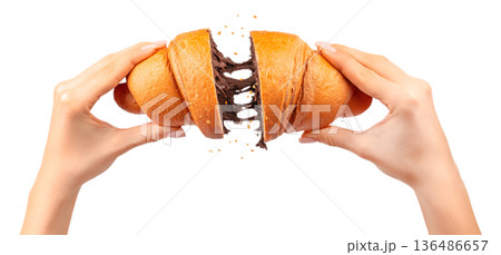 Woman breaking croissant with melted chocolate filling stretch isolated on white Woman breaking croissant with melted chocolate filling stretch isolated on white 136486657