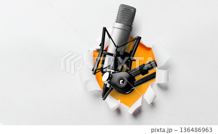 Podcast microphone breaks through a heart-shaped hole on a white background Podcast microphone breaks through a heart-shaped hole on a white background 136486963