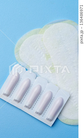 Different types of cosmetic nail tips on a blue background with nail products visible Different types of cosmetic nail tips on a blue background with nail products visible 136486971