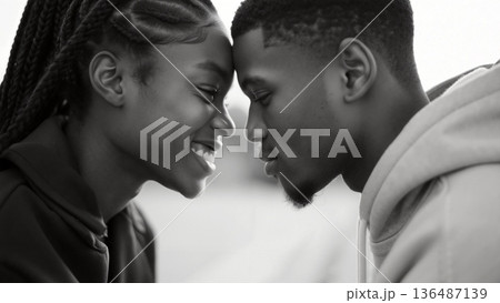 Close up black and white portrait of young african american couple foreheads touching 136487139