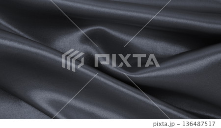Smooth elegant dark grey silk or satin luxury cloth texture as abstract background. Luxurious background design Smooth elegant dark grey silk or satin luxury cloth texture as abstract background. Luxurious background design 136487517