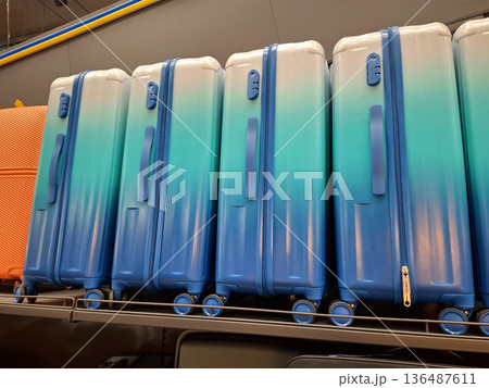 Blue suitcases are sold in the supermarket 136487611