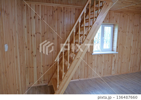 A new wooden staircase leading to the second floor of the house 136487660