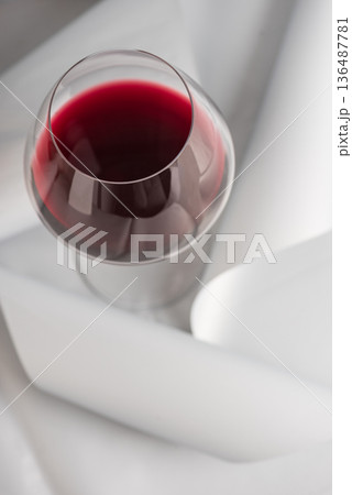 Red Wine Glass on Minimal Gray Background. Elegant Modern Beverage Concept Red Wine Glass on Minimal Gray Background. Elegant Modern Beverage Concept 136487781