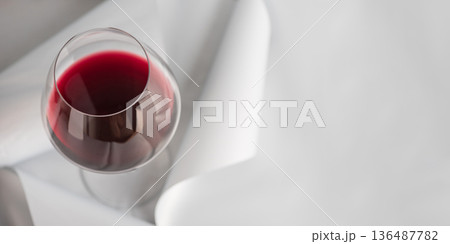 Red Wine Glass on Minimal Gray Background. Elegant Modern Beverage Concept Red Wine Glass on Minimal Gray Background. Elegant Modern Beverage Concept 136487782