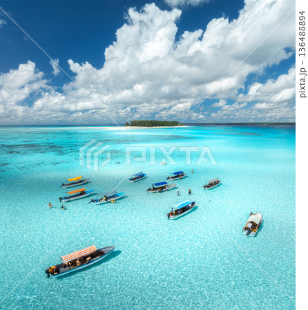 Aerial top view of tourist boats in sea with turquoise water Aerial top view of tourist boats in sea with turquoise water 136488894