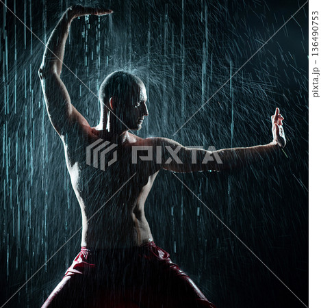 Shirtless man doing qigong under the rain Shirtless man doing qigong under the rain 136490753