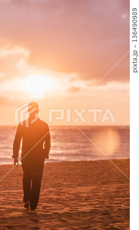 Man walking beach representing solitude inspiration and dream Man walking beach representing solitude inspiration and dream 136490989