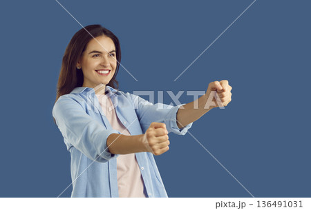 The girl imagines that she turns the steering wheel of her car. The girl imagines that she turns the steering wheel of her car. 136491031
