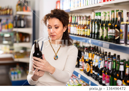 Adult woman choosing beer in store 136496472