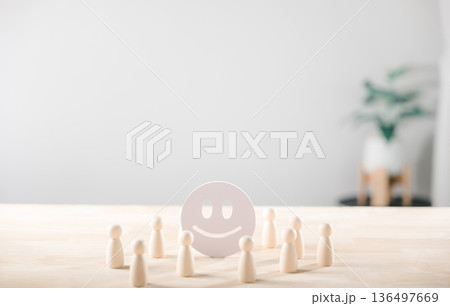 Feedback concept illustrates positive customer satisfaction with happy face icon surrounded by wooden figures for service evaluation and quality rating Feedback concept illustrates positive customer satisfaction with happy face icon surrounded by wooden figures for service evaluation and quality rating 136497669