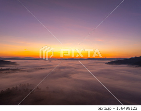 Soft Morning Light and Mist Creating a Dreamlike Mountain Landscape Soft Morning Light and Mist Creating a Dreamlike Mountain Landscape 136498122