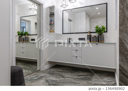Modern minimalist hallway interior with marble floor and long white console Modern minimalist hallway interior with marble floor and long white console 136498902
