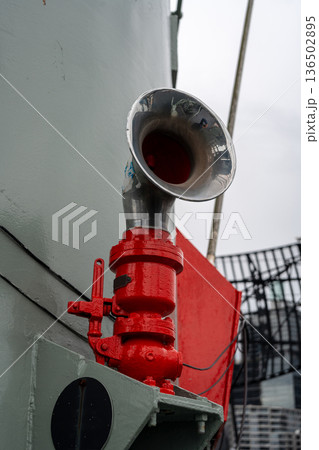 Metal ship horn mounted on a military vessel with red piping Metal ship horn mounted on a military vessel with red piping 136502895