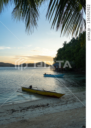 Boat at sunset on Bolilanga Island, Togian archipelago, Sulawesi, Indonesia Boat at sunset on Bolilanga Island, Togian archipelago, Sulawesi, Indonesia 136502922