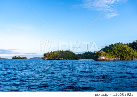 Sunset over Waleakodi Island, Togian archipelago, Sulawesi, Indonesia coastal landscape Sunset over Waleakodi Island, Togian archipelago, Sulawesi, Indonesia coastal landscape 136502923