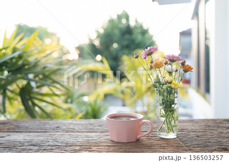 Pink coffee cup and Chrysanthemum flowers in a glass vase Pink coffee cup and Chrysanthemum flowers in a glass vase 136503257