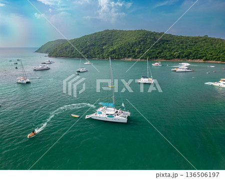 Small private yacht in the sea with beautiful turquoise wave and lightly stretched clouds Small private yacht in the sea with beautiful turquoise wave and lightly stretched clouds 136506197