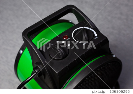 Temperature and heater mode controller. Light indicates fan heater power status and power modes. Setting temperature for warming cold room. Device for heating room. Increasing the temperature 136506296