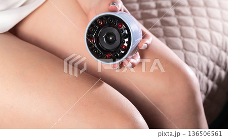 Girl gives herself a massage with a portable vacuum massager on her body. Anti-cellulite and relaxing massage, close-up Girl gives herself a massage with a portable vacuum massager on her body. Anti-cellulite and relaxing massage, close-up 136506561