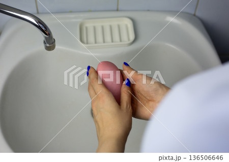 Girl washes her hands with soap. Healthy habit. Washing hands before eating and after using toilet is important part of modern life. Hand hygiene, gentle soap for body care 136506646