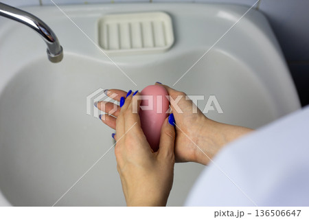 Close up photo of women hands with soap. Handwashing against sink. Concept of daily handwashing routine. Skin hygiene, protection from bacteria. Process everyone does Close up photo of women hands with soap. Handwashing against sink. Concept of daily handwashing routine. Skin hygiene, protection from bacteria. Process everyone does 136506647