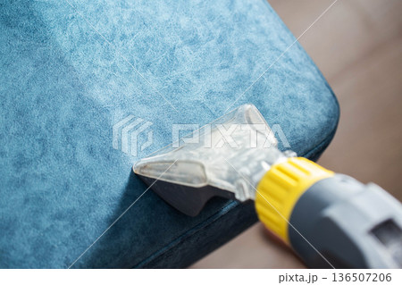 Cleaning upholstery with a vacuum attachment for deep cleaning fabric surfaces at home Cleaning upholstery with a vacuum attachment for deep cleaning fabric surfaces at home 136507206