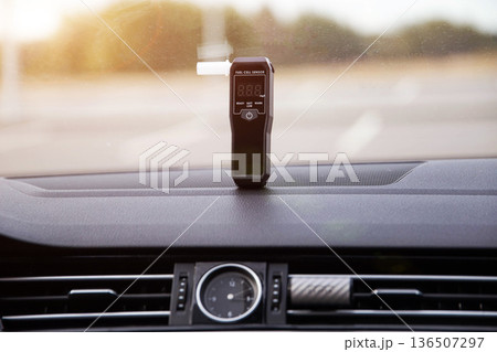 Alcohol Tester On Vehicle Dashboard With Sun Flare. Sobriety Check Device In Morning Light. 136507297