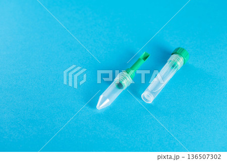 An empty test tube with biomaterial for medical research on a blue background. Stool tests for infections and corpograms. Copy space for text 136507302