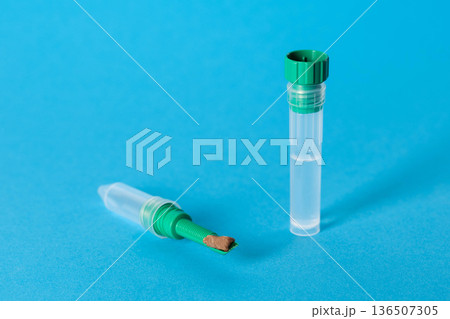 A test tube with a stool sample on a blue background, concept of stool research for pathogenic microflora and dysbacteriosis. Copy space for text A test tube with a stool sample on a blue background, concept of stool research for pathogenic microflora and dysbacteriosis. Copy space for text 136507305
