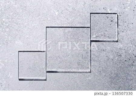 Glass squares on a gray background. Copy space Glass squares on a gray background. Copy space 136507330