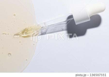 Liquid cosmetic product for the skin or medicine in a pipette. Copy space 136507331