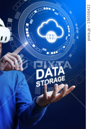 Man in virtual reality headset shows data storage concept in digital space with glowing cloud icon 136508422