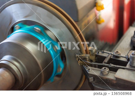 Automotive brake disc machining on lathe machine in workshop precision metal cutting process for vehicle maintenance and repair industrial engineering close up Automotive brake disc machining on lathe machine in workshop precision metal cutting process for vehicle maintenance and repair industrial engineering close up 136508968