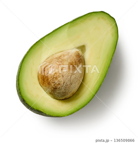 Fresh green avocado half with pit isolated on white background, top view Fresh green avocado half with pit isolated on white background, top view 136509866