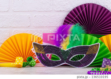 Vibrant Mardi Gras background with mask, beads, and festive decorations 136510195