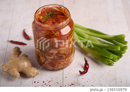 Traditional Korean Kimchi in Glass Jar with Ingredients Traditional Korean Kimchi in Glass Jar with Ingredients 136510979