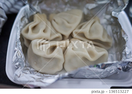Close-up of Khinkali steamed Georgian dumplings on foil 136513227