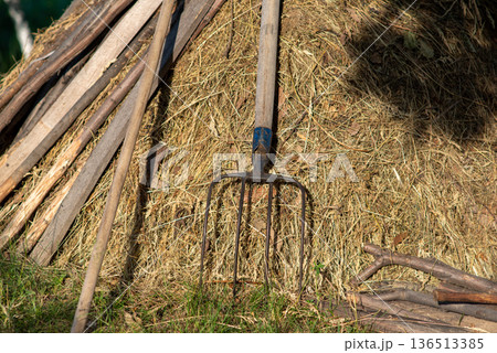 Pitchfork Leaning on Haystack in Rural Farmyard 136513385