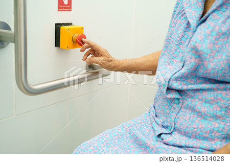 Asian elderly woman press emergency button in toilet. Asian elderly woman press emergency button in toilet. 136514028