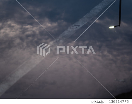 Reflection of street lights and sky on flood puddle on the road Reflection of street lights and sky on flood puddle on the road 136514776
