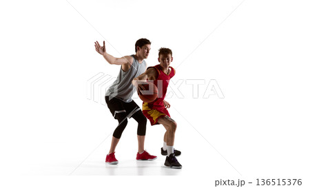 Basketball defender raising arm to block shot in studio isolated on white background. Basketball defender raising arm to block shot in studio isolated on white background. 136515376
