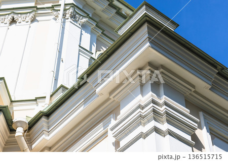 White classical building exterior with ornate cornice White classical building exterior with ornate cornice 136515715