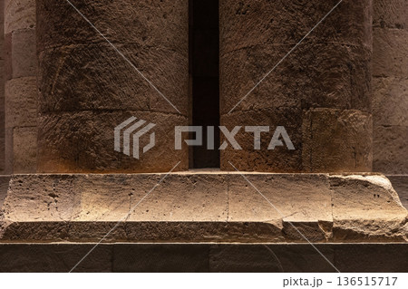 Warm-lit ancient stone columns and a massive base Warm-lit ancient stone columns and a massive base 136515717