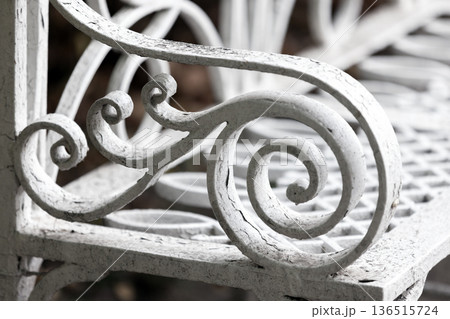 A detailed close-up of a decorative white wrought iron A detailed close-up of a decorative white wrought iron 136515724