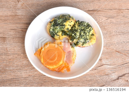 Obanyaki grilled Japanese pancake stuffed spinach and chicken ham with cheese on plate Obanyaki grilled Japanese pancake stuffed spinach and chicken ham with cheese on plate 136516194
