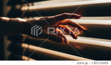 Sunlight Rays Through Blinds Casting Shadows on Dark Wall 136516469